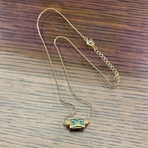 Rise and Shine 14k gold plated necklace with a rising sun and three flowers.